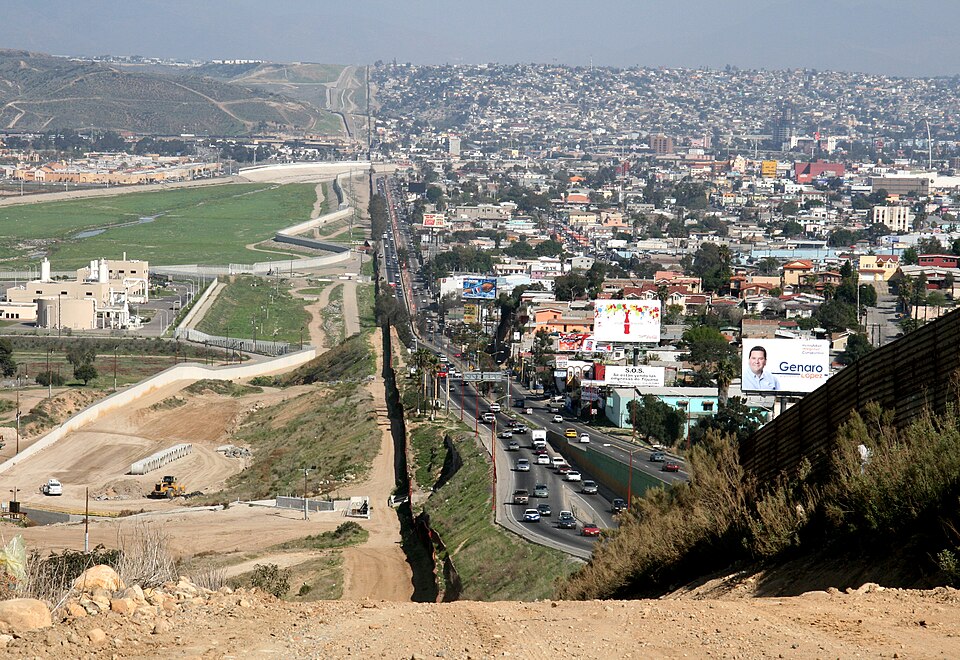 A small fence separates densely-populated Tijuana, Mexico, right, from the United States in the Bord