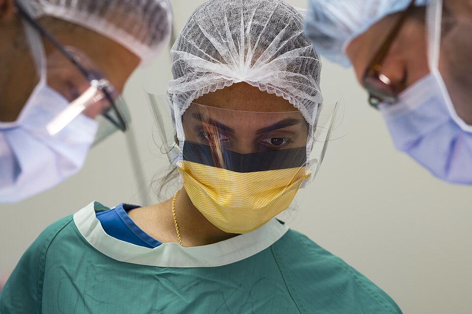 A technician assists during surgery inside a newly opened operating room at Paramibo’s Academic Hosp