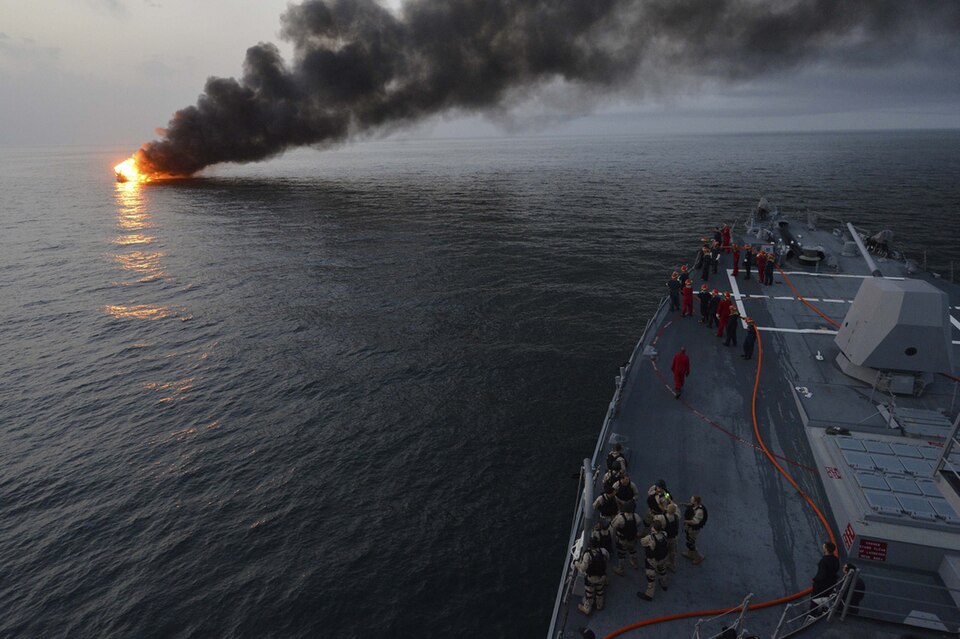 U.S. Sailors aboard the guided missile destroyer USS William P. Lawrence (DDG 110) prepare to offer rescue assistance to a burning vessel March 11, 2013, during a transit in the Strait of Hormuz. The William P. Lawrence was deployed to the U.S. 5th Fleet area of responsibility to promote maritime se