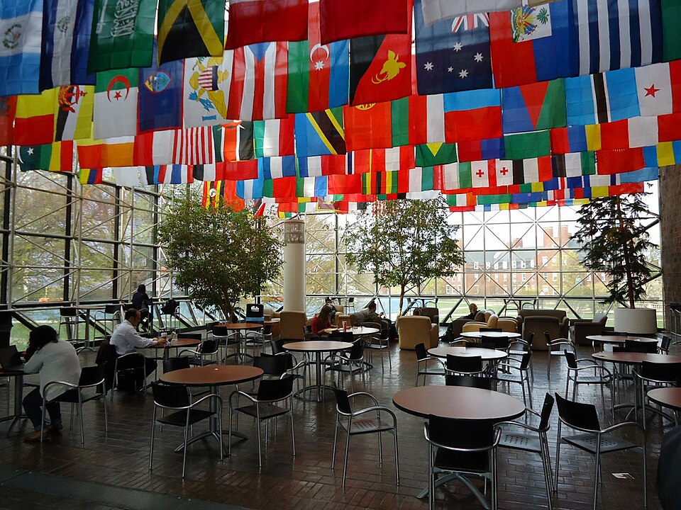 Courtyard inside Wilson Commons, with flags representing the attendance of students from various cou