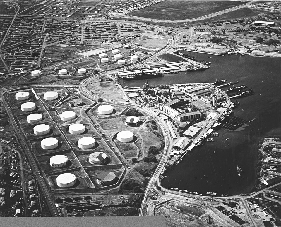 Aerial view of the Pearl Harbor submarine base (right center) with the fuel farm at left, looking so