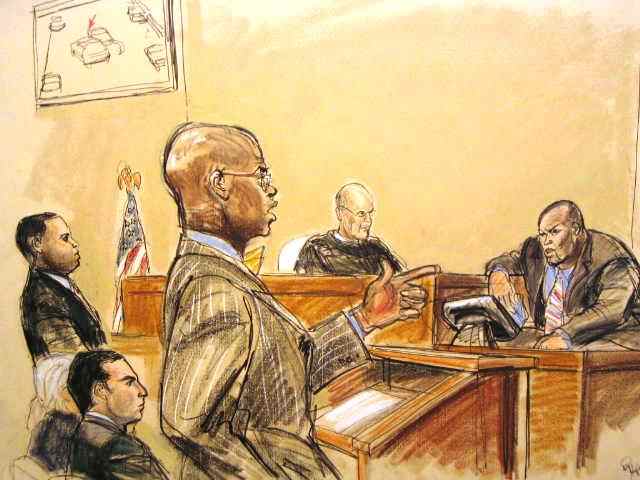 Defendant Gescard Isnora stands as his defense attorney Anthony Ricco cross examines witness Joseph 