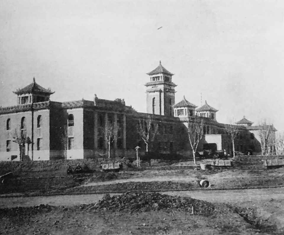 Original caption: "Here, with a scene typical of the feverish building activity in Hsinking, capital