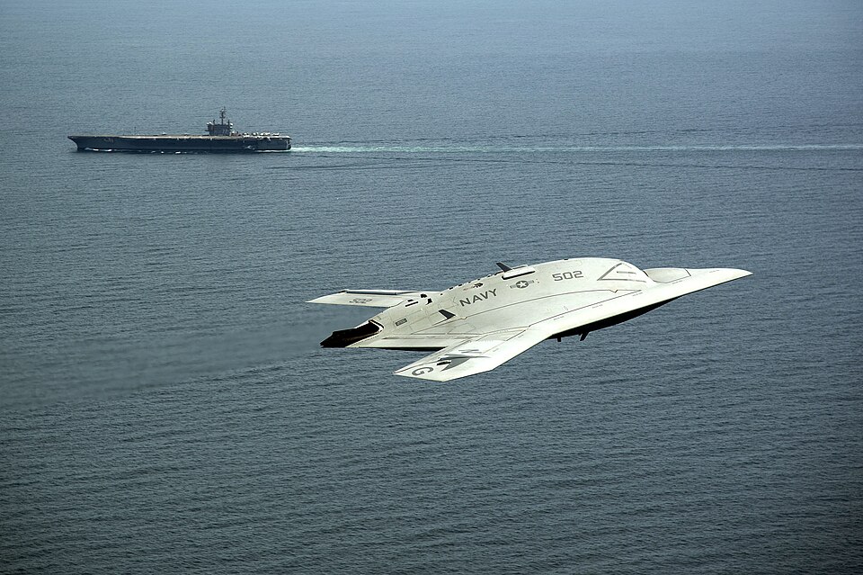 An X-47B Unmanned Combat Air System demonstrator flies near the aircraft carrier USS George H.W. Bush (CVN 77) after launching from the ship May 14, 2013, in the Atlantic Ocean. The George H.W. Bush became the first aircraft carrier to successfully catapult launch an unmanned aircraft from its fligh