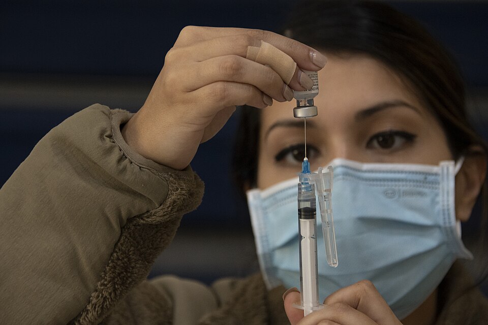 A Reserve Citizen Airman assigned to the 307th Medical Squadron prepares a syringe before administer