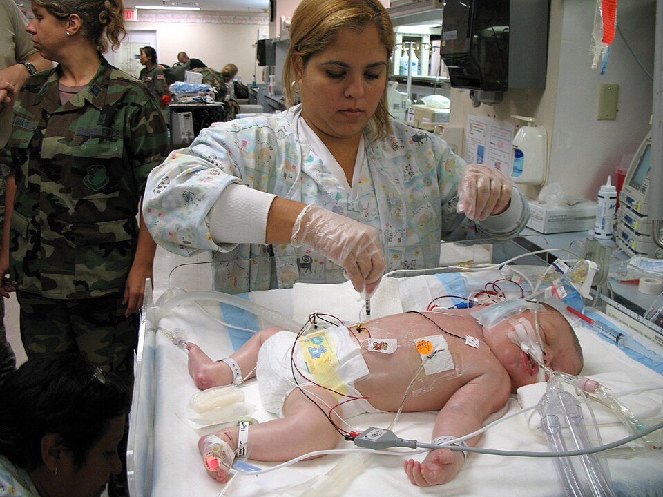 Respiratory therapist Michelle Sirra takes a blood sample from a 3-day-old patient in preparation fo