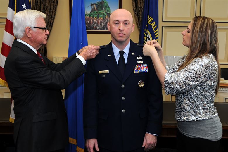 Lt. Col. Danny Davis, Air Force District of Washington A1 deputy director, pins on the rank of Colon