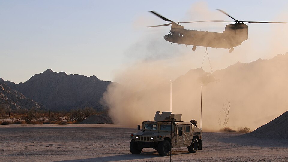 U.S. Soldiers assigned to 1st Combat Aviation Brigade, 1st Infantry Division, utilize a CH-47 Chinook helicopter to drop off a Ground Based Operational Surveillance System (Expeditionary) (G-BOSS(E)) to U.S. Soldiers assigned to the 759th Military Police Battalion in Wellton, Ariz., on June 9, 2025.