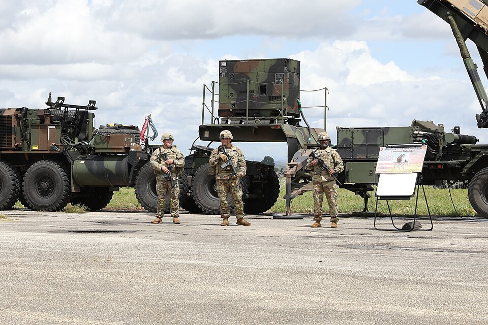 U.S. Army Soldiers from the 5th Battalion, 7th Air Defense Artillery stand beside a Patriot surface-