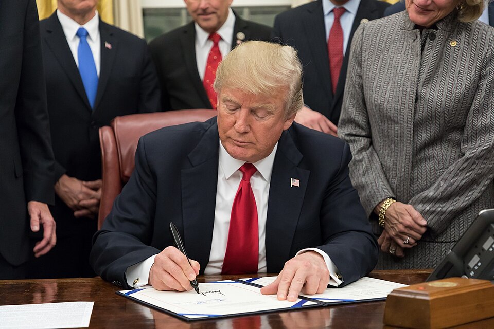 Donald Trump signing legislation, January 2018.