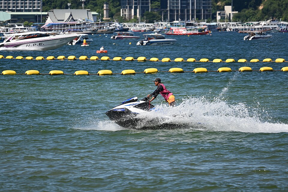 This photo shows a personal watercraft (commonly known as a jet ski) being ridden across a body of w