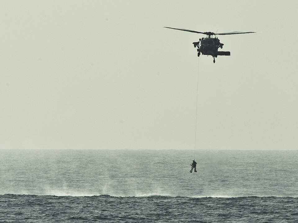 ARABIAN SEA (Feb. 5, 2012) Search and rescue swimmers are hoisted into an MH-60S Sea Hawk helicopter
